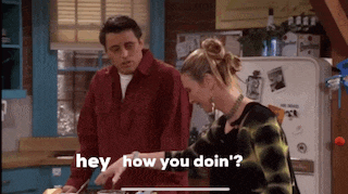a man and a woman are standing in a kitchen and the woman says hey how you doin '?