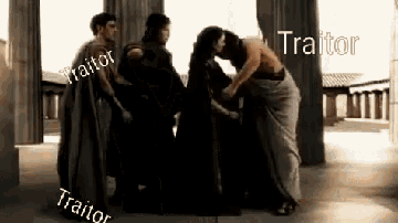 a group of people are standing next to each other in a room and talking to each other .