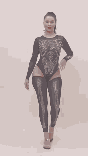 a woman is wearing a skeleton costume with rhinestones