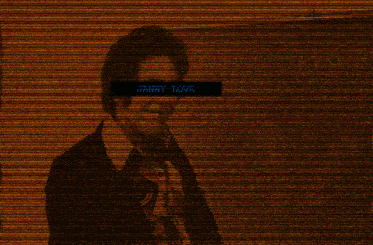 a man in a suit and tie is talking on a phone with a green screen behind him that says " i love you "