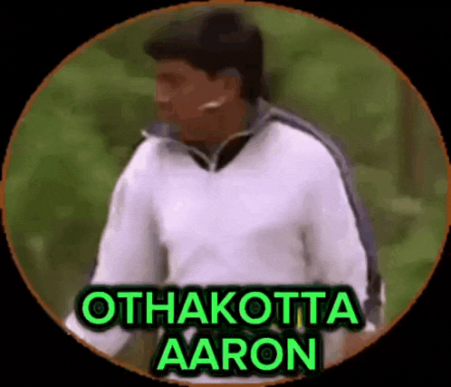a man in a white jacket is standing in a circle with the words `` othakotta aaron '' written in green .