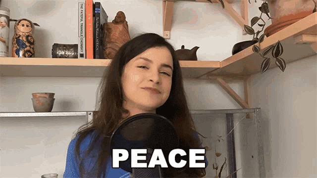a woman stands in front of a microphone with the word peace above her head