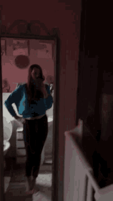 a woman taking a selfie in front of a mirror in a bathroom