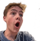 a young man with his mouth open is making a funny face .