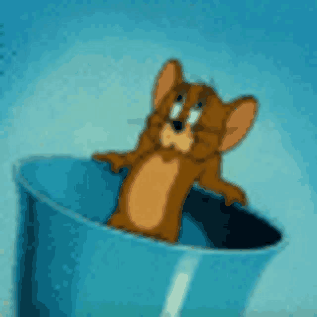 a cartoon mouse is sitting in a blue bucket .