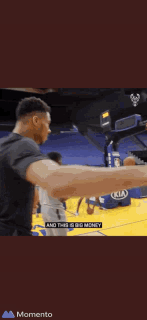 a basketball player wearing a black shirt that says bucks