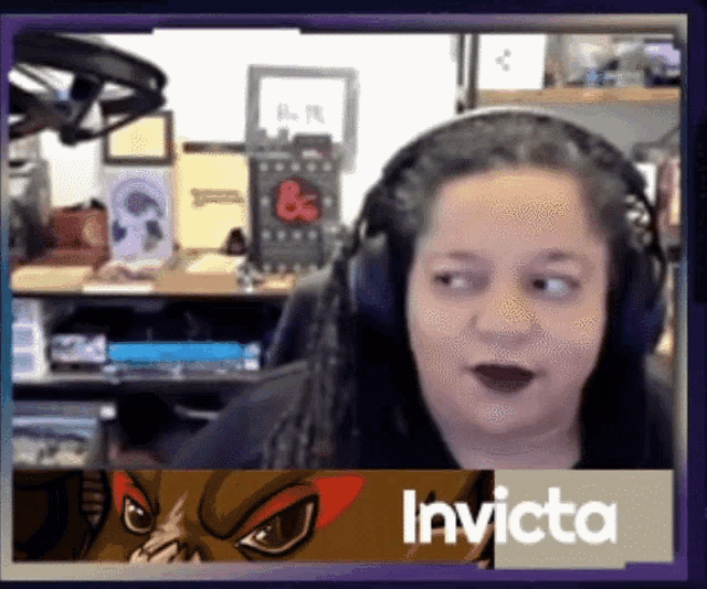 a woman wearing headphones with the name invicta on the bottom