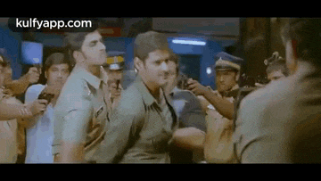 a man is standing in a crowd of police officers .