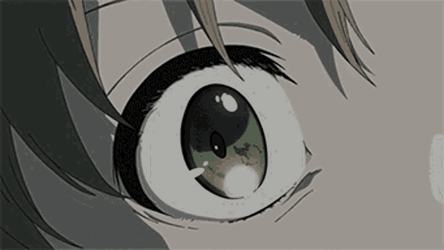 a closeup of a person 's eye with a green pupil