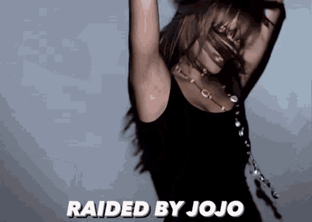 a woman in a black tank top is dancing with the words raided by jojo below her