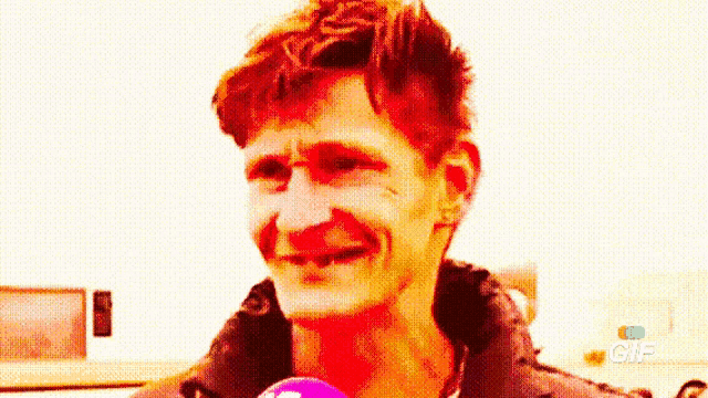 a close up of a man 's face with a gif logo in the corner .