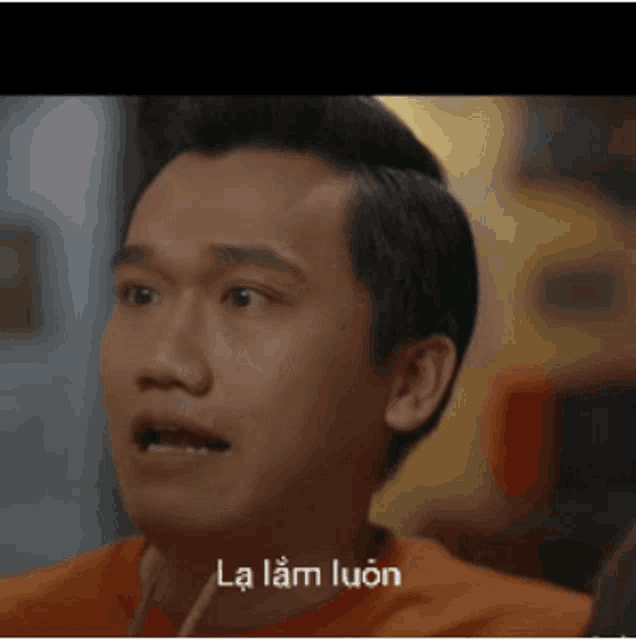 a close up of a man 's face with the words la lam luôn written on it .