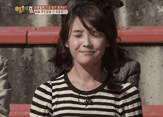 a woman in a striped shirt is making a funny face in a foreign language