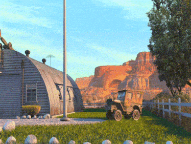 a military vehicle is parked in front of a building in the desert
