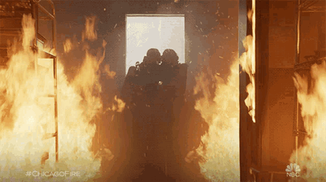 two firefighters are standing in a doorway surrounded by flames with #chicagofire written on the bottom