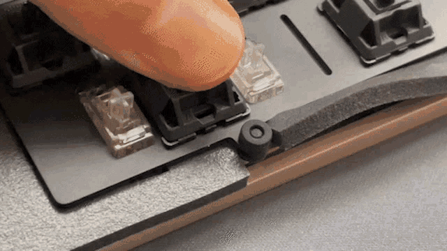 a close up of a person 's finger pressing a button on a keyboard