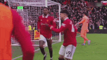 a soccer player with the number 49 on his shorts is celebrating