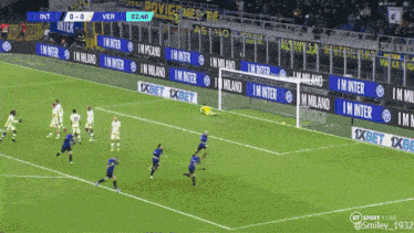 a soccer game is being played on a field with advertisements for 1xbet and milano