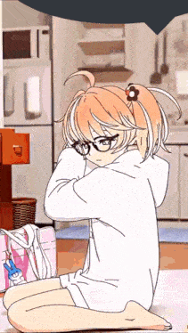 a girl with glasses is sitting on the floor