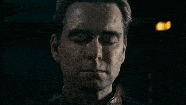 a close up of a man 's face with a tear running down his face