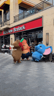 a group of stuffed animals are dancing in front of a store called new bcelack