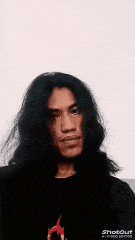 a man with long hair is making a funny face with a yellow sign that says woooo