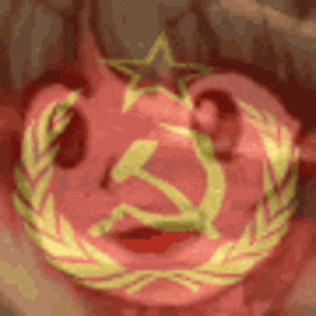 a red background with a hammer and sickle and a laurel wreath