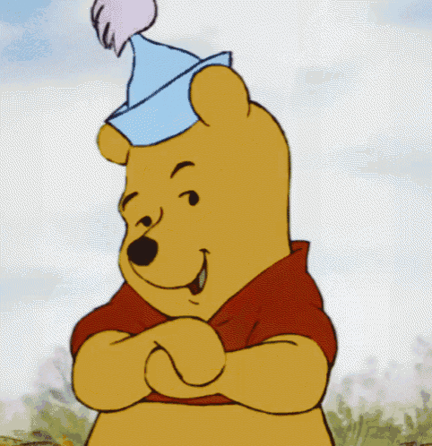 winnie the pooh is wearing a blue party hat with a pink pom pom