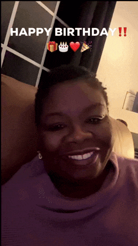 a woman in a purple sweater is smiling with the words happy birthday behind her