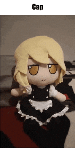 a stuffed doll with yellow hair is sitting on a bed under a caption that says cap
