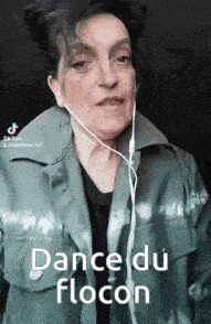 a woman wearing headphones and a jacket says dance du flocon .
