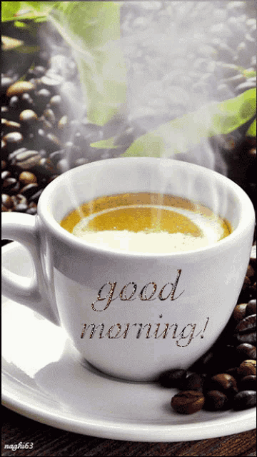 a cup of coffee on a saucer with the words good morning written on it