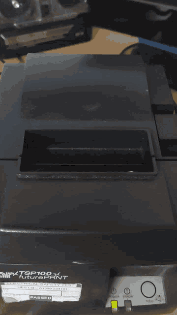 a black tsp100 receipt printer has a piece of paper that says you on it