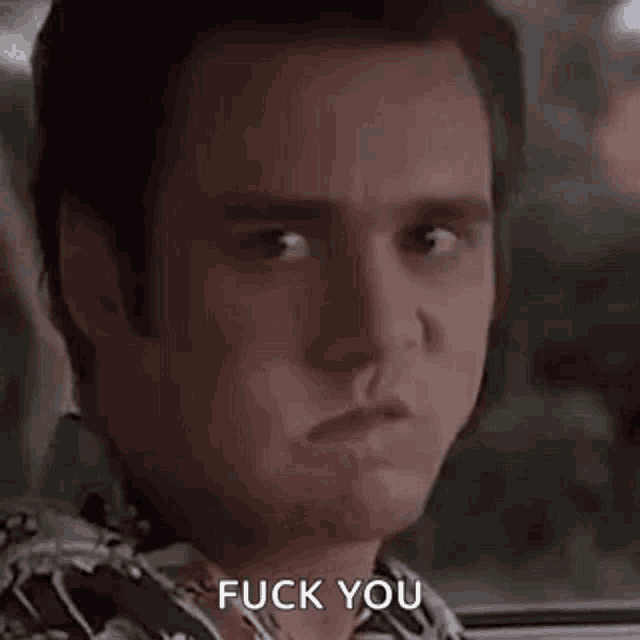 a close up of a man making a face and saying `` fuck you '' .