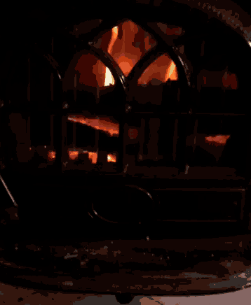 a fireplace with a flame coming out of the window