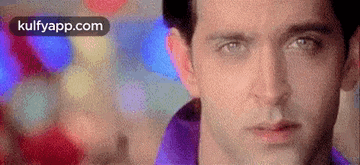 a close up of a man 's face with a blurry background