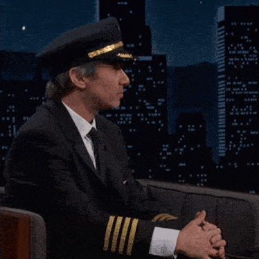 a man in a pilot 's hat is talking about people calling it that