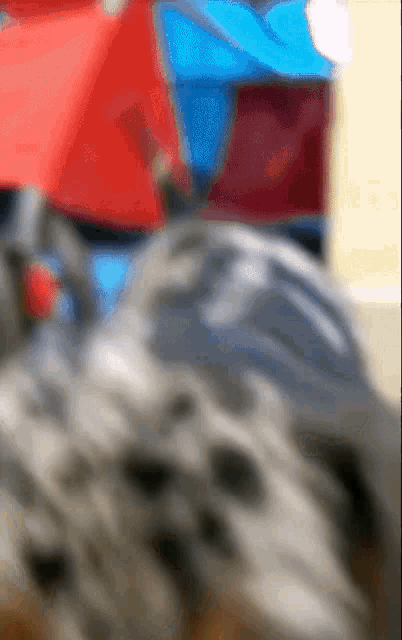 a blurry picture of a person 's face with a red and blue background