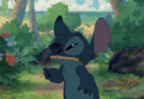 stitch from disney 's lilo and stitch is standing in the grass with his mouth open and looking at the camera .