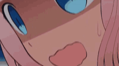 a close up of a girl 's face with pink hair and blue eyes .