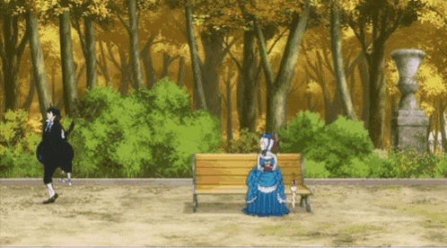 a woman in a blue dress sitting on a park bench