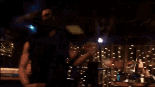 a man singing into a microphone on stage
