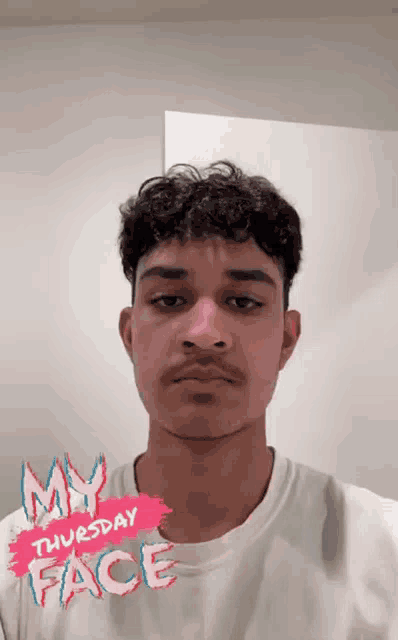 a young man wearing a white t-shirt with the words my thursday face written on it