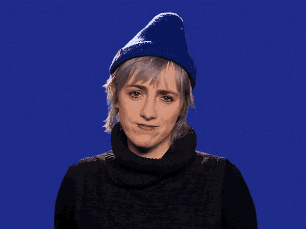 a woman wearing a blue hat and black sweater