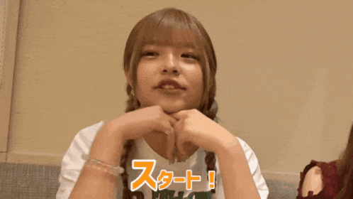 a girl with a braided hair wearing a white t-shirt that says ' start ' on it
