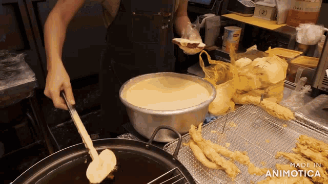 a person preparing food in a kitchen with the words made in animatica on the bottom right