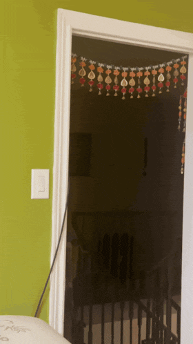 a door with a white trim and a light switch
