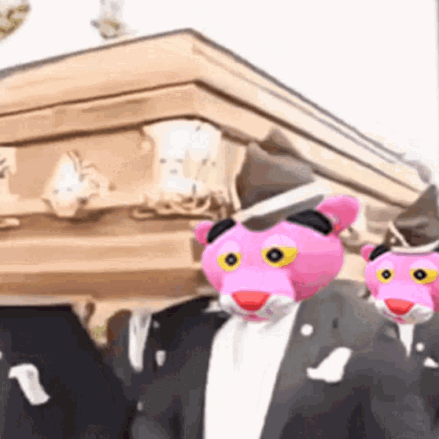 a group of pink panthers are carrying a coffin