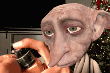 a close up of a person holding a bottle of perfume