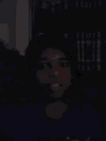 a blurry picture of a person 's hand in the dark